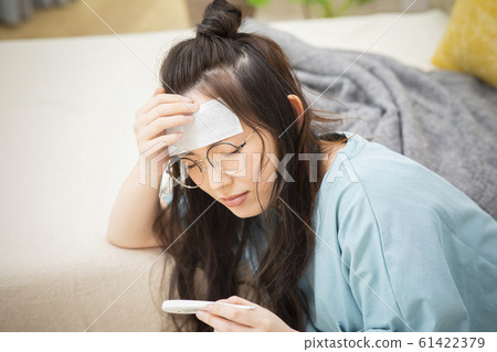 Woman cold fever influenza poor health thermometer Woman cold fever influenza poor health thermometer 61422379