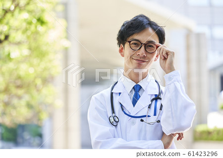 A young man wearing a white suit A young man wearing a white suit 61423296