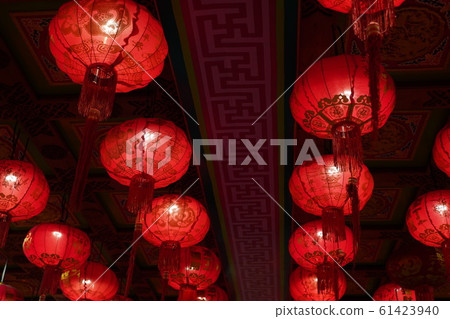 Many illuminated red Chinese lanterns with some Chinese characters on it 61423940