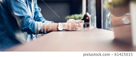Man using smartphone, During leisure time. Man using smartphone, During leisure time. 61425015