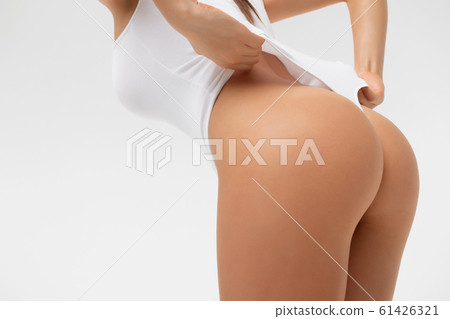 Crop sexy woman touching swimsuit posing in studio Crop sexy woman touching swimsuit posing in studio 61426321
