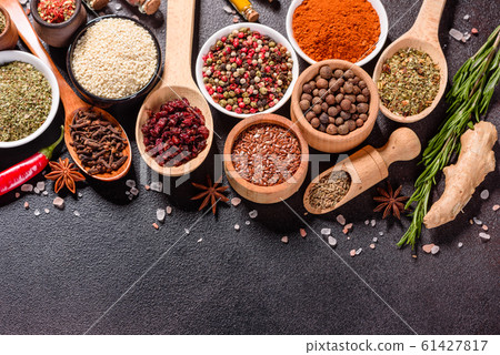Spices and herbs over black stone background 61427817