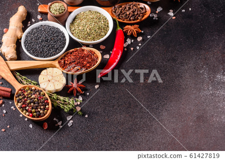 Spices and herbs over black stone background 61427819