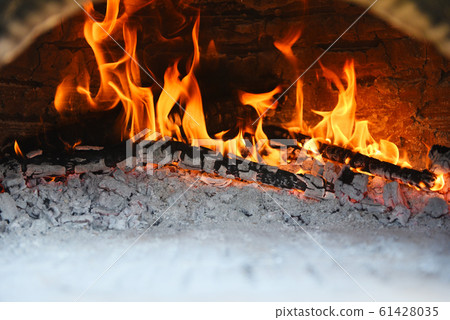 fireplace with log wood burning clay stove fire in fireplace with log wood burning clay stove fire in 61428035