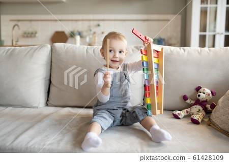 Pretty little baby girl playing with xylophone Pretty little baby girl playing with xylophone 61428109