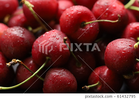 Bright red cherries covered with water droplets. Photos from above, the red background. 61432795