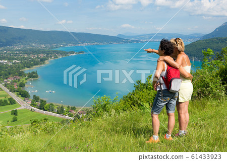 Two women watching view of Lake Annecy Two women watching view of Lake Annecy 61433923