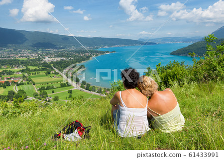 Two women watching  view of Lake Annecy 61433991