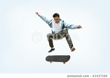 Caucasian young skateboarder riding isolated on a white background 61437384