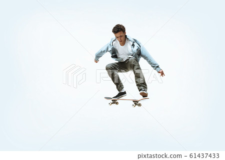 Caucasian young skateboarder riding isolated on a white background 61437433