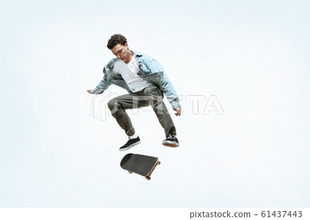 Caucasian young skateboarder riding isolated on a white background 61437443
