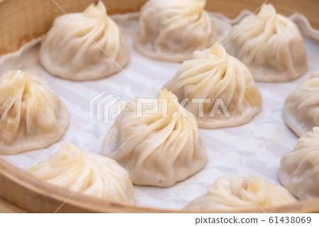 Xiao long bao soup dumpling buns with chopsticks 61438069
