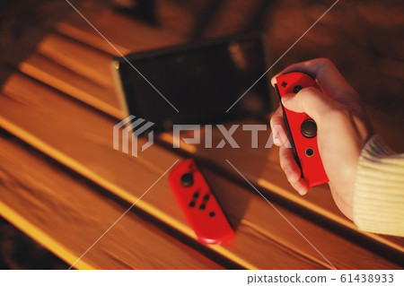 Men who play game machines in the park Japan 61438933