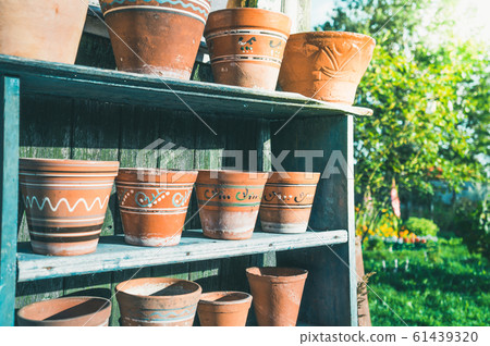 Vintage clay pots with ornamental pattern standing Vintage clay pots with ornamental pattern standing 61439320
