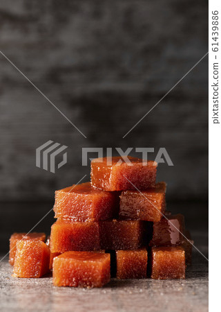 dices of quince cheese on a table 61439886