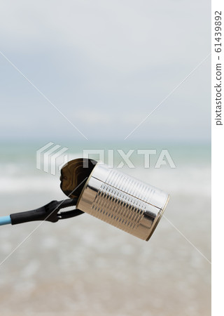 collecting garbage in a lonely beach collecting garbage in a lonely beach 61439892