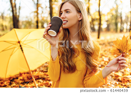 young girl in autumn Park sitting on a blanket, 61440439
