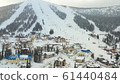 Mounting skiing resort. People skiing and snowboarding from the mountain.Beautiful view from above 61440484