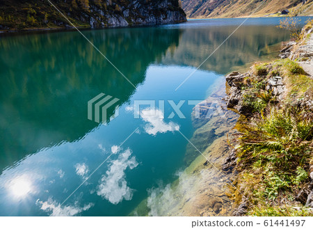 Sunny autumn alpine Tappenkarsee lake and rocky Sunny autumn alpine Tappenkarsee lake and rocky 61441497