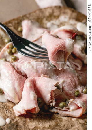 Vitello tonnato sliced veal Vitello tonnato sliced veal 61441688