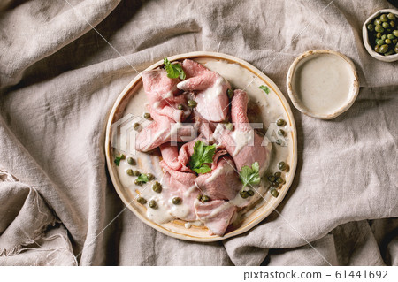 Vitello tonnato sliced veal Vitello tonnato sliced veal 61441692