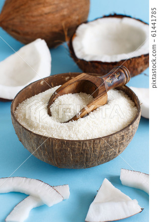 Coconut flour in a bowl with coconut pieces Coconut flour in a bowl with coconut pieces 61441785