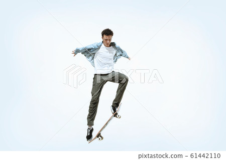 Caucasian young skateboarder riding isolated on a white background 61442110