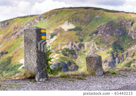 Blue and yellow square hiking markers, trail blazing symbol, Krkonose mountains, Czech Republic 61443215