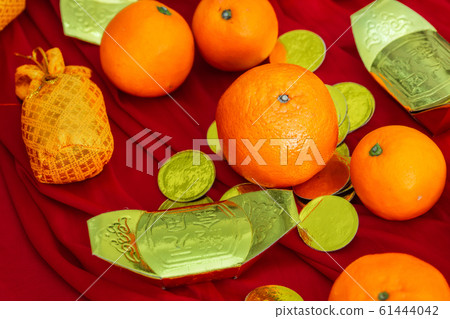 Oranges and gold on red fabric , Chinese New Year Oranges and gold on red fabric , Chinese New Year 61444042