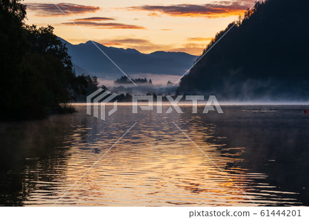 Peaceful autumn Alps mountain lake. Sunrise Peaceful autumn Alps mountain lake. Sunrise 61444201