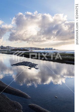 Breathtaking sunrise on beach in El Medano, Tenerife, Canary Islands, Spain, sunny cloudy blue sky with copy space Breathtaking sunrise on beach in El Medano, Tenerife, Canary Islands, Spain, sunny cloudy blue sky with copy space 61444751