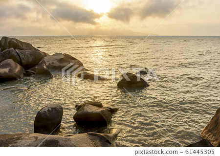 Sunset through the rocks in summer from Ilhabela Sunset through the rocks in summer from Ilhabela 61445305