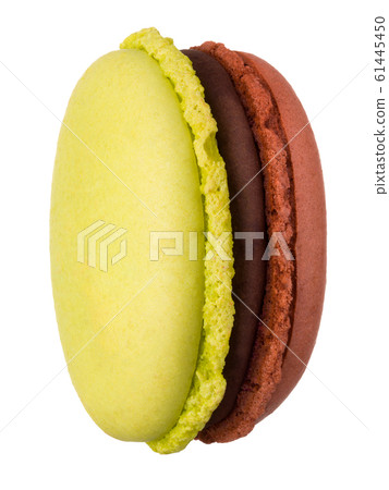Macro photo of french caramel and pistachio macaroon isolated on white Macro photo of french caramel and pistachio macaroon isolated on white 61445450