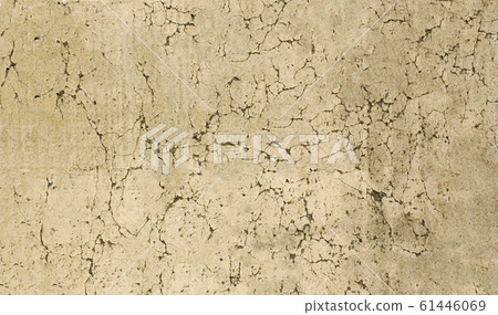 Damaged wall of the old house with peeling yellow plaster 61446069