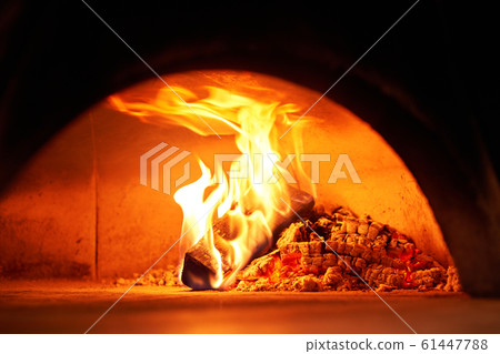 Beautiful festive wreath of fresh spruce on Gray wall. Xmas circlet with red and gold ornaments and balls. Christmas mood. 61447788