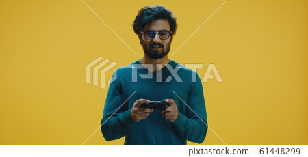 Young man playing video game 61448299