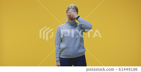 Woman covering her eyes Woman covering her eyes 61449186