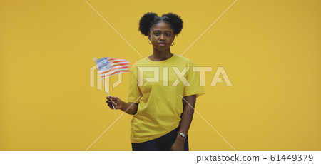 Woman waving US flag 61449379