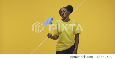 Woman waving EU flag Woman waving EU flag 61449390