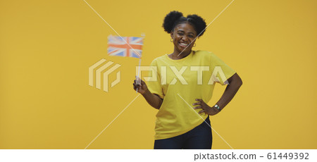 Woman waving British flag Woman waving British flag 61449392