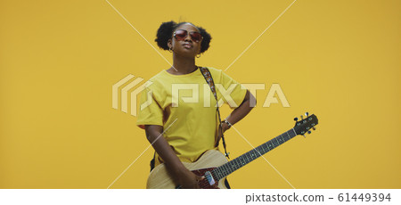 Young woman playing electric guitar Young woman playing electric guitar 61449394