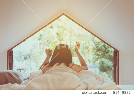 Woman stretching in tent after wake up in the morning,Happy and relaxing time 61449882