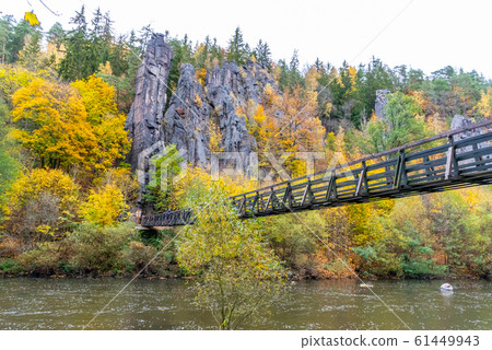 Swing Bridge over Ohre River at Svatos Rocks, Czech: Svatosske skaly, at autumn time, Czech Republic Swing Bridge over Ohre River at Svatos Rocks, Czech: Svatosske skaly, at autumn time, Czech Republic 61449943