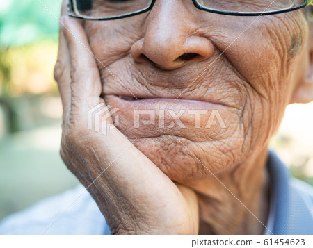 Close up of Elderly man biting on cotton gauze Close up of Elderly man biting on cotton gauze 61454623