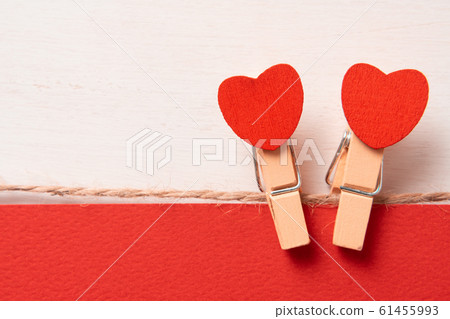 lovers symbol. Clothes pegs with red wooden hearts. lovers symbol. Clothes pegs with red wooden hearts. 61455993