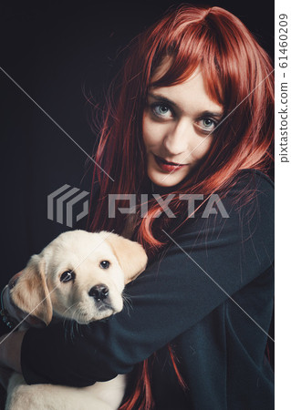 Young woman with her labrador retriever dog on a 61460209
