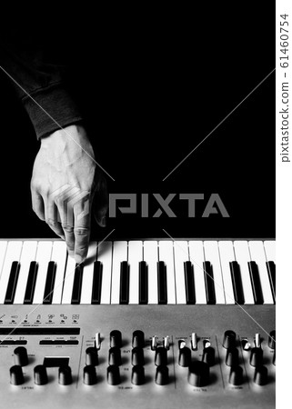 male musician hand playing music keyboard synthesizer, black and white. music background male musician hand playing music keyboard synthesizer, black and white. music background 61460754