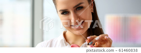 Happy beautiful woman put silver quarter in slot portrait 61460838