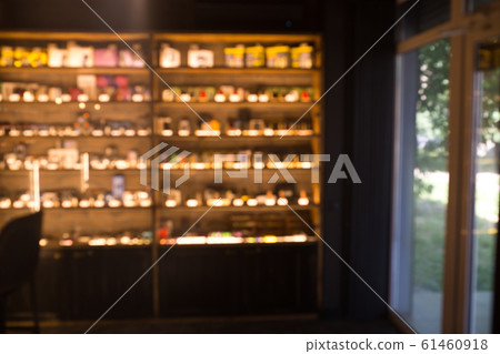 Blurry showcase in vape shop close up. Blurred showcase with the goods. Blurry showcase in vape shop close up. Blurred showcase with the goods. 61460918