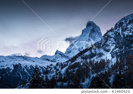 Snowy summit of Matterhorn after sunset 61460920